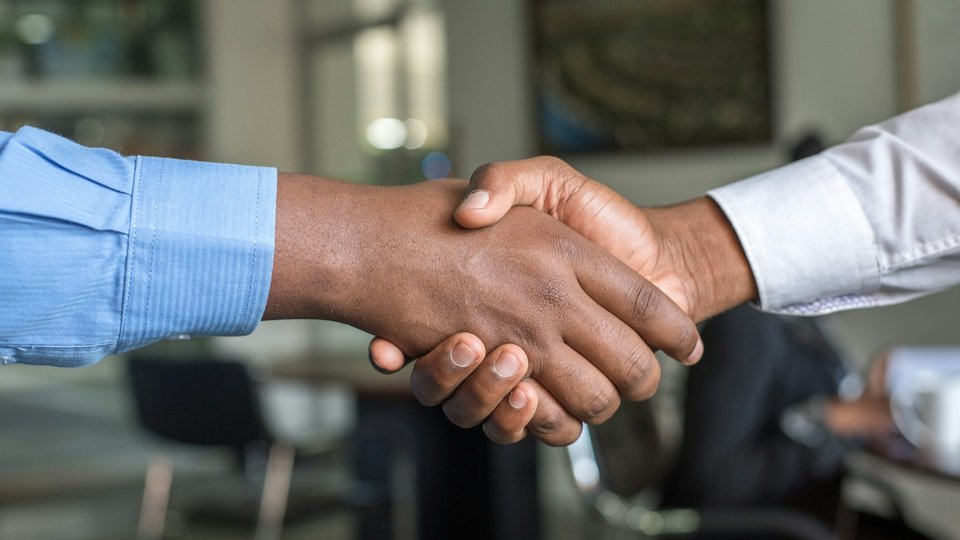 Business handshake after a policy review meeting